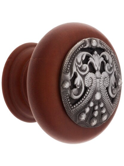 1 1/2 inch Diameter Regal Crest Knobs in Cherry/Antique Pewter.